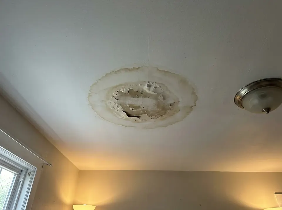 Water stain on a ceiling from a roof leak